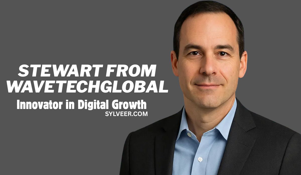Promotional image featuring a man in a dark suit and light blue shirt, with a neutral gray background. Text on the left reads: “Stewart from WavetechGlobal – Innovator in Digital Growth.” The website “sylveer.com” is displayed below the tagline. The image conveys a professional and corporate tone.