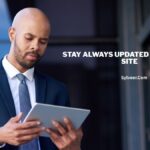 A man in a business suit stands outside a modern glass building, focused on using a digital tablet. Text on the right side reads “STAY ALWAYS UPDATED WITH TXEPC SITE” with “Sylveer.com” below it.